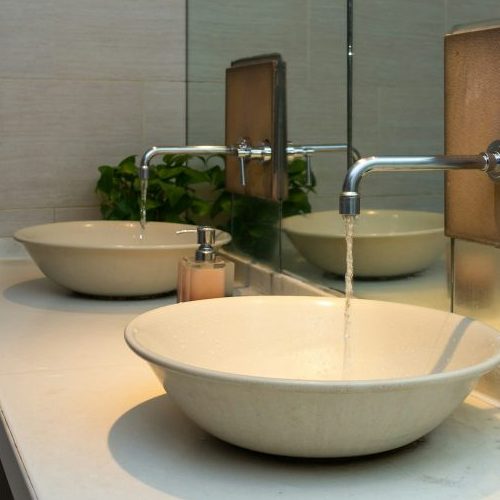 Chrome faucet with washbasin in modern bathroom