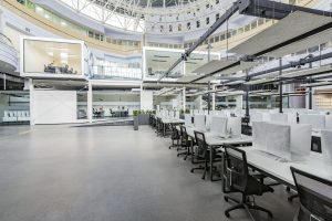 Interior of empty coworking space with covered computers